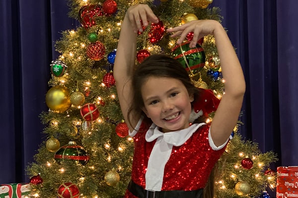 Girl in front of a Christmas tree
